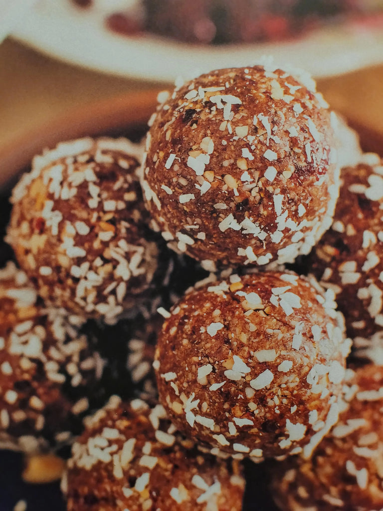 A small pile of no-bake CBD coconut oat balls, homemade treats for dogs.